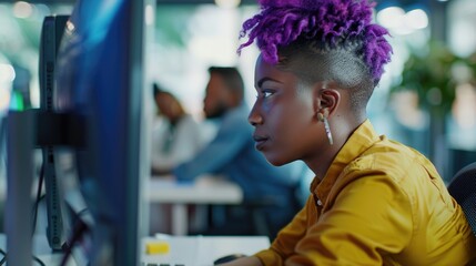 Poster - Woman with purple hair is sitting at a computer. She is wearing a yellow shirt and is focused on her work