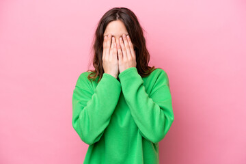 Wall Mural - Young caucasian woman isolated on pink background covering eyes by hands