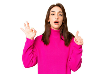 Wall Mural - Young caucasian woman over isolated chroma key background showing ok sign and thumb up gesture