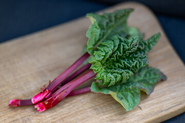 fresh rhubarb on wooden table