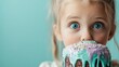 © Maximages  - A lovable child with large blue eyes is curiously looking over a frosted cake with sparkling sprinkles, embodying innocence and the joy of sweet exploration.