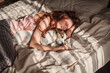 © Tatyana Gladskih - Young woman sleeping with dog on bed