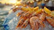 © komgritch - Fresh shrimp on ice with lemon slices, vibrant sunset background.