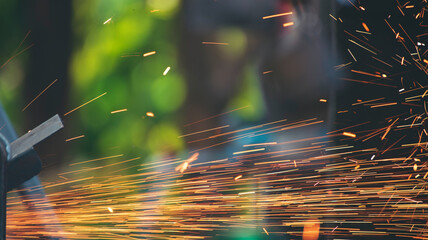 Welding machinery iron metal sparking fire flame close up construction Worker hands. Men hands protect glove Hot flame metal work cutting fire iron workshop. Locksmith Welding machine metal industry