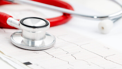 stethoscope on heart cardiogram