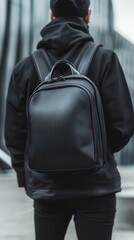 A person sports a sleek black urban backpack that complements the city’s minimalist style