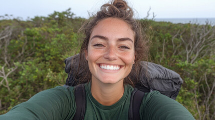 A smiling woman with backpack enjoys nature, surrounded by greenery. Her joyful expression reflects love for adventure and outdoors