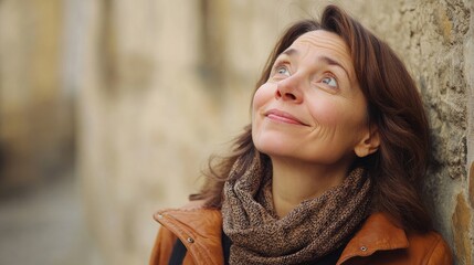 Wall Mural - Middle-aged woman looking up and smiling, expressing happiness