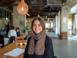 © sid - Arab Businesswoman in Hijab Collaborating with Colleague in a Modern Open Workspace