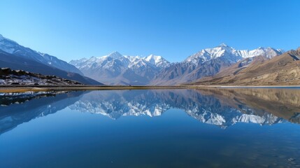 Aufkleber - A serene mountain lake reflecting snow-capped peaks under a clear blue sky, Alpine setting with pristine nature, Tranquil style