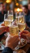 © natakot - A group of people raising their champagne glasses for a toast at a festive celebration, symbolizing joy, success, and social gatherings. The image highlights celebration and shared moments.