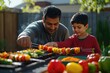 © Running opossum - South asian father and son grilling vegetable skewers on a sunny day in their backyard