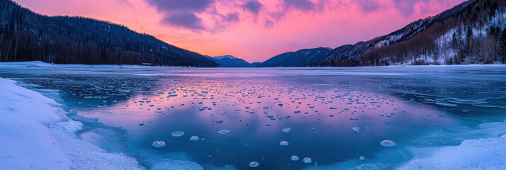 Wall Mural - serene winter landscape featuring frozen lake surrounded by snow covered mountains under colorful sunset sky. tranquil scene evokes sense of peace and beauty