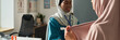 © pressmaster - Muslim medical professional in uniform assisting patient in well-equipped office. Diverse healthcare environment with modern medical equipment visible