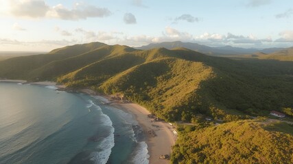 Poster - Aerial view of a secluded beach with lush green mountains in the background.