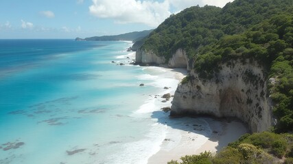 Wall Mural - A view of a white sand beach and clear blue water.