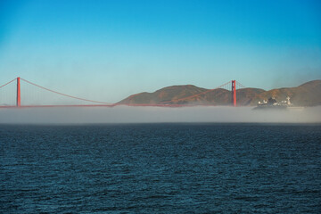 Super deluxe luxury cruiseship cruise ship ocean liner yacht Explora arrival in to San Francisco port with Golden Gate and misty foggy cloud bank over water