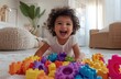 © thiquynh - A happy child playing with colorful building blocks in the living room, laughing and having fun while making toys