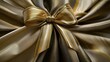 © Nikolai - Close-up of a shiny gold bow with intricate loops and glossy texture, perfect for gift wrapping.