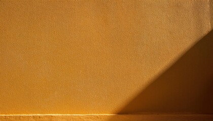 Poster - Warm Golden Wall with Diagonal Sunlight and Shadows, Minimalist Textured Background for Design and Mood Concepts, Highlighting Abstract Play of Light in Photography, Zen and Calm Ambience