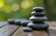 © Lilly - Pyramid of spa stones for massage. Blurred nature in the background.