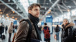 © evgenia_lo - Caucasian male traveler at an airport, hopeful and looking ahead, winter attire.