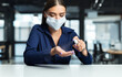 © Prostock-studio - Hygiene Concept. Portrait of woman wearing mask using small portable antibacterial hand sanitizer spray on hands