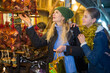 © JackF - Happy teen girl with her loving mother choosing Xmas decoration on outdoor market