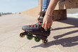 © ADDICTIVE STOCK - Young man fitting inline skates outdoors