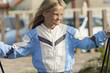 © ADDICTIVE STOCK - Young girl enjoying the outdoors in a vibrant jacket