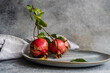 © ADDICTIVE STOCK - Ripe whole pomegranates on gray plate