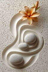 Tranquil arrangement of stones and flowers on textured sand pattern in a serene setting