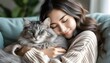 © Jeofran - Cozy moments of a young lady and her fluffy grey tabby cat enjoying cuddles on a comfortable couch