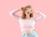 © Pixel-Shot - Pretty young woman with beautiful gerbera flower on pink background