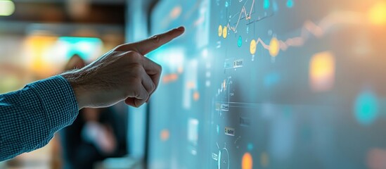 Wall Mural - a hand points at a large screen with charts and graphs, likely discussing business strategy.