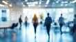 © Prapan - Defocused office setting with blurred figures moving in the background,