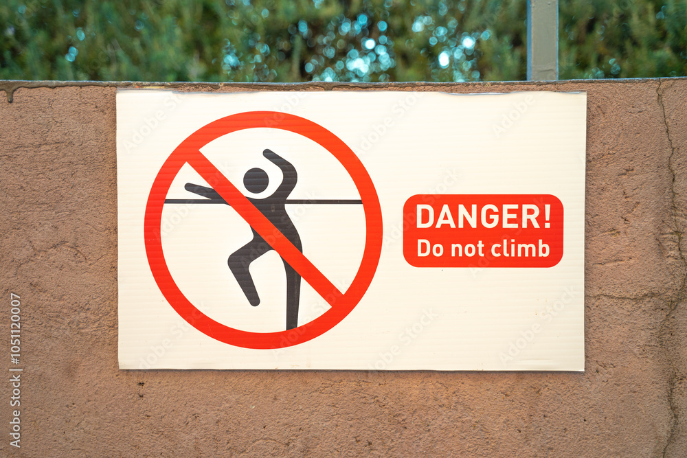clear warning sign on a wall, illustrating the hazard of climbing ...