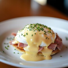 a classic egg benedict with poached eggs, ham, and hollandaise sauce
