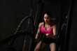 © kamonrat - Fit Woman Exercising with Battle Ropes in Gym, Building Strength and Endurance with Intense Workout, Focused on Fitness Training