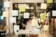© peopleimages.com - Sticky note, night and office with blur for reminder, schedule planning or tasks on agenda at office. Paper, stickers or post with glass board for brainstorming, ideas or mind map at modern workplace