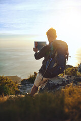 Selfie, photography and man with backpack, hiking and view with adventure, vacation and ocean. Outdoor, hiker and healthy person with tablet, coastline and connection with internet, travel or journey