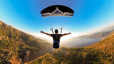 Paragliding pilot flying over a beach with arms outstretched, capturing the essence of adventure, freedom, and exhilaration in flight.