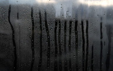 Poster - A window pane covered in condensation with streaks of water running down the surface.