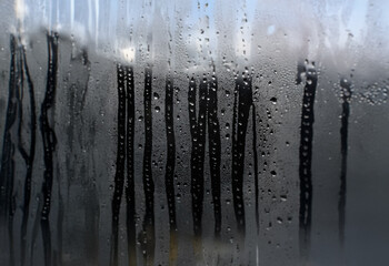 Aufkleber - Condensation has formed on a window pane, obscuring the view outside.