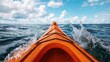 © Thritti - Water splashing off the sides of a sea kayak as it navigates through waves, kayak wave splash, adventure motion
