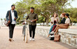 © peopleimages.com - Friends, urban park and walking with morning commute and bike together with talk in city. Eco friendly, people and town with group, outdoor and conversation on pavement with travel and communication