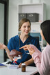 © NINENII - Female doctor and patient are talking and consulting at the table in a medical clinic or hospital health service.