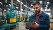 © Tamii - A man in a modern factory with a tablet in his hands