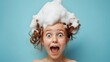 © Olga - A face of a surprised cute redhead young girl with a foam on her hair