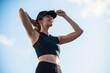 © Westend61 - Happy woman wearing cap and standing under sky on sunny day